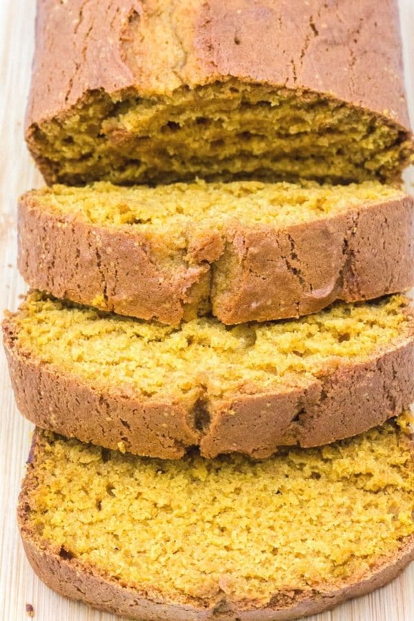 loaf of pumpkin bread sliced on a cutting board