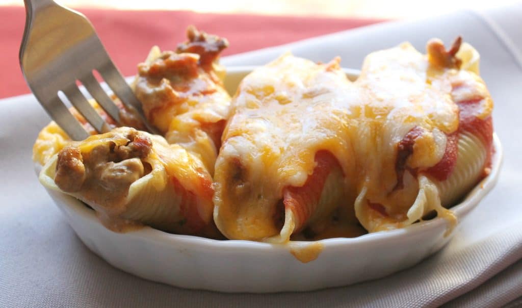 These Cheesy Mexican Stuffed Shells are an easy but delicious meal and a spin-off of Italian stuffed shells. Make these for Taco Tuesday! Mexican Stuffed Shells | Easy Mexican Recipes | Taco Tuesday | Quick meals