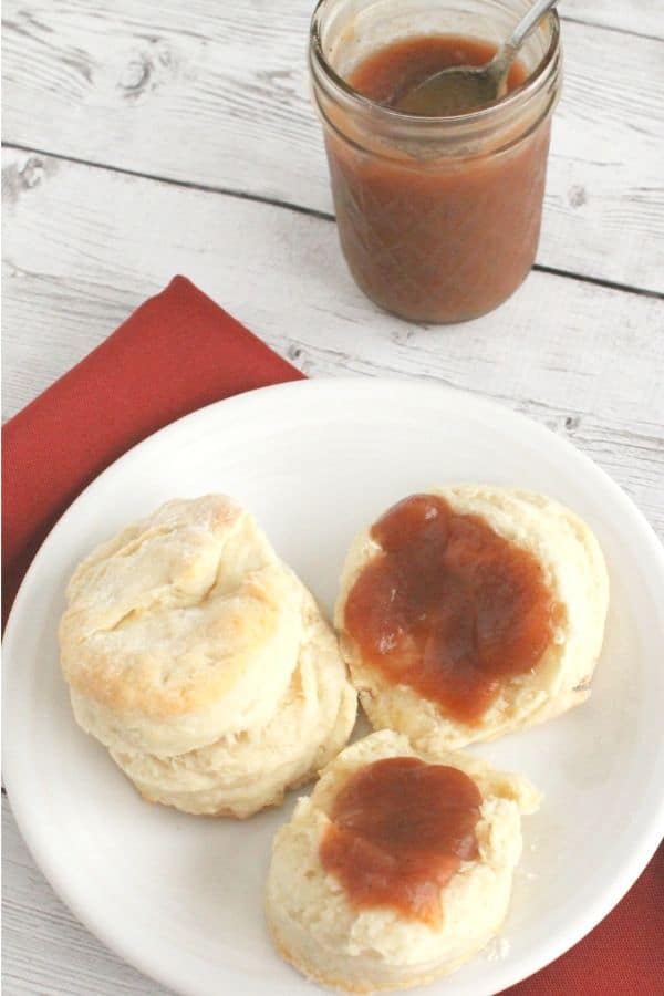 crockpot apple butter spread on a biscuit
