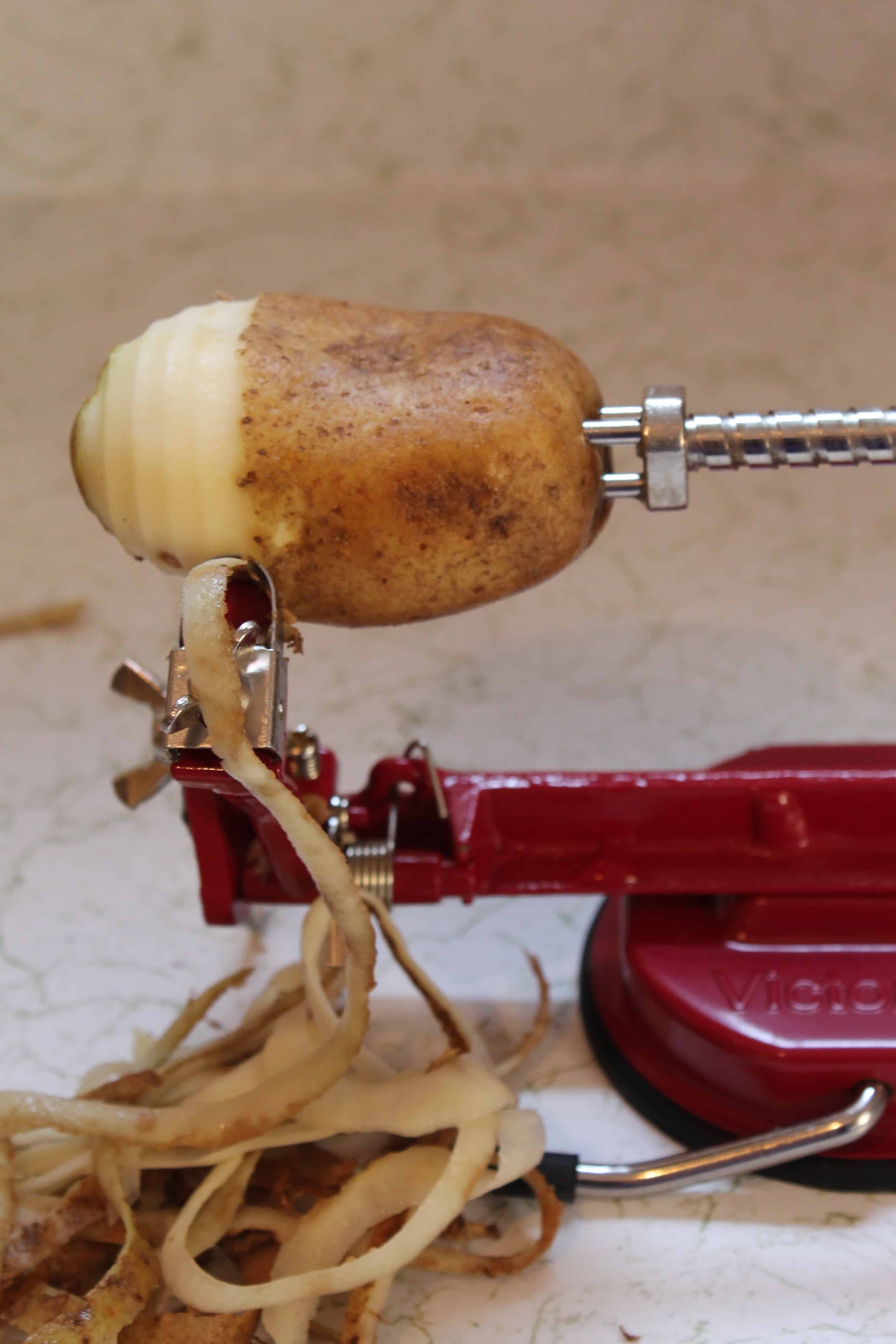 a "johnny apple peeler" being used to peel russet potatoes for homemade mashed potatoes
