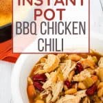 white bowl of bbq chicken chili next to a skillet of cornbread