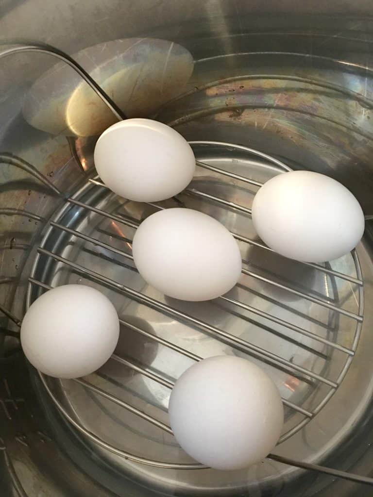 eggs on a trivet inside of the insert pot of an Instant Pot