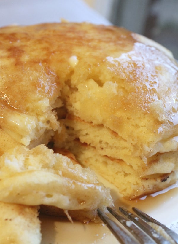 a stack of homemade pancakes on a china plate