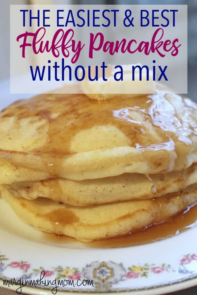 stack of homemade pancakes on a china plate, topped with butter and syrup