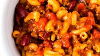 Instant Pot chili mac served in a white bowl with a spoon