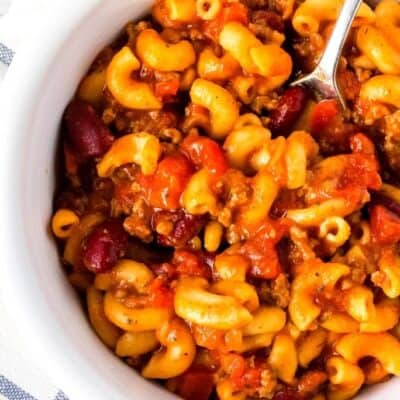 Instant Pot chili mac served in a white bowl with a spoon
