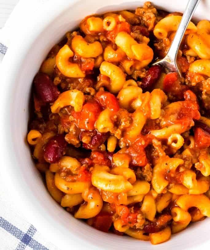 Instant Pot chili mac served in a white bowl with a spoon