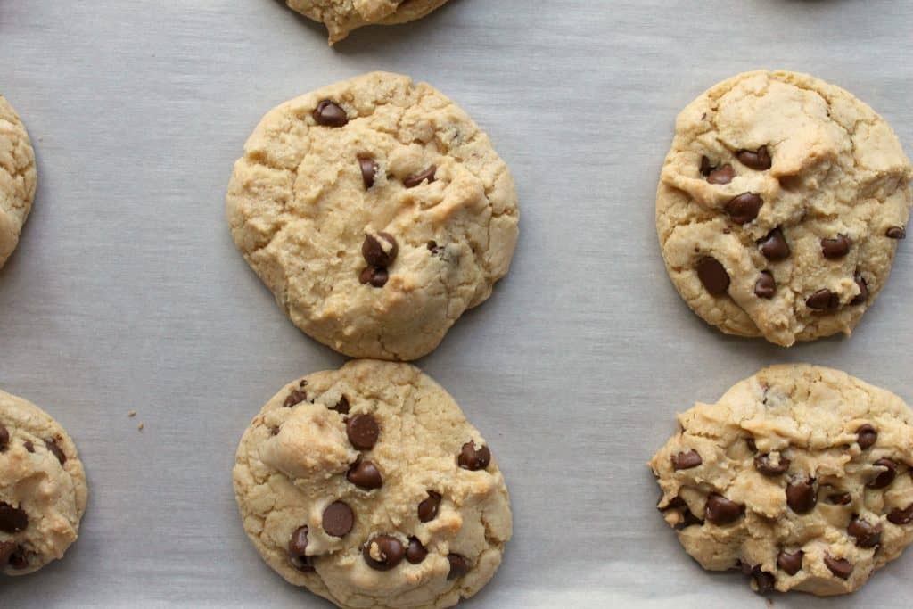 These perfectly chewy chocolate chip cookies will knock your socks off! They are delightfully soft, chock full of chips, and have a deep flavor from the brown sugar and melted butter. Click through to learn how to make them!