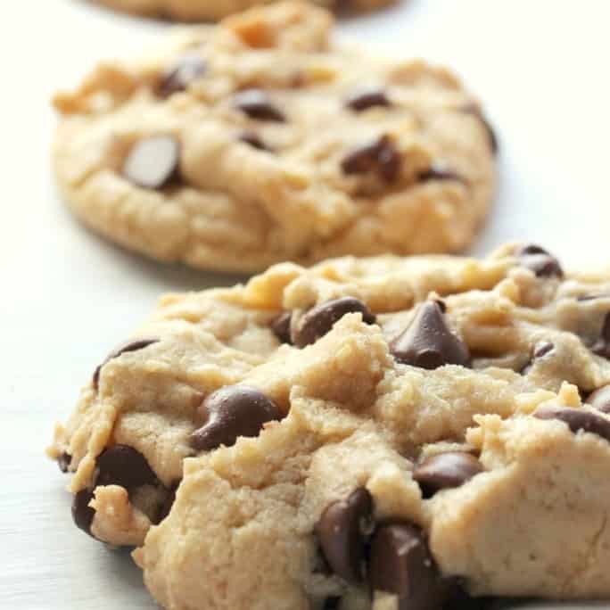 These perfectly chewy chocolate chip cookies will knock your socks off! They are delightfully soft, chock full of chips, and have a deep flavor from the brown sugar and melted butter. Click through to learn how to make them!
