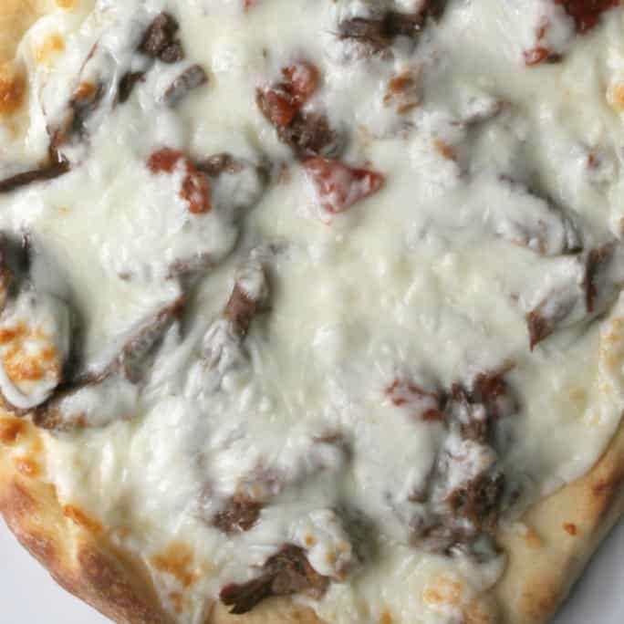These spicy beef flatbread pizzas are made easy by using the pressure cooker to cook tender, flavorful beef in a fraction of the normal time.