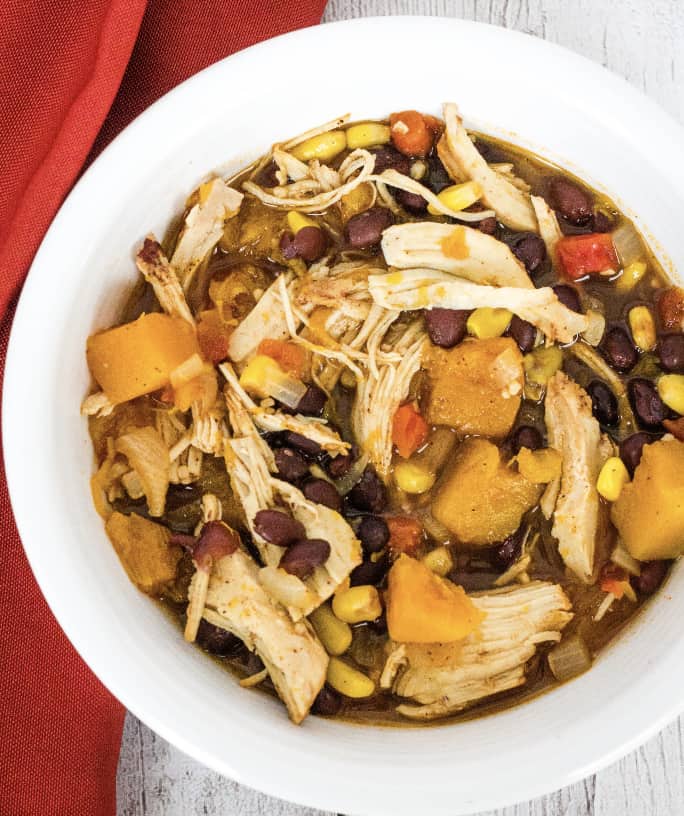 white bowl filled with instant pot chicken and sweet potato enchilada soup