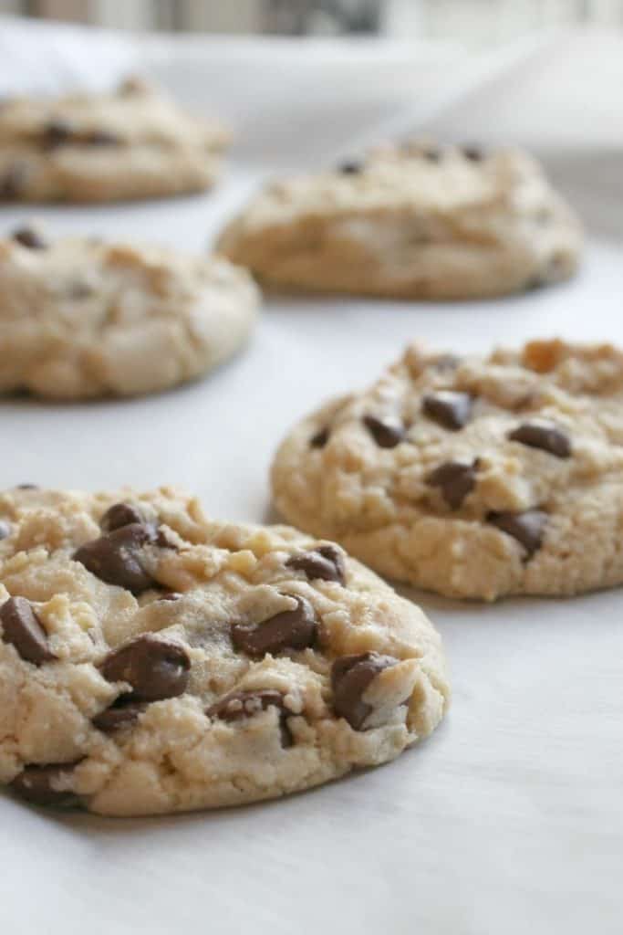 These perfectly chewy chocolate chip cookies will knock your socks off! They are delightfully soft, chock full of chips, and have a deep flavor from the brown sugar and melted butter. Click through to learn how to make them!