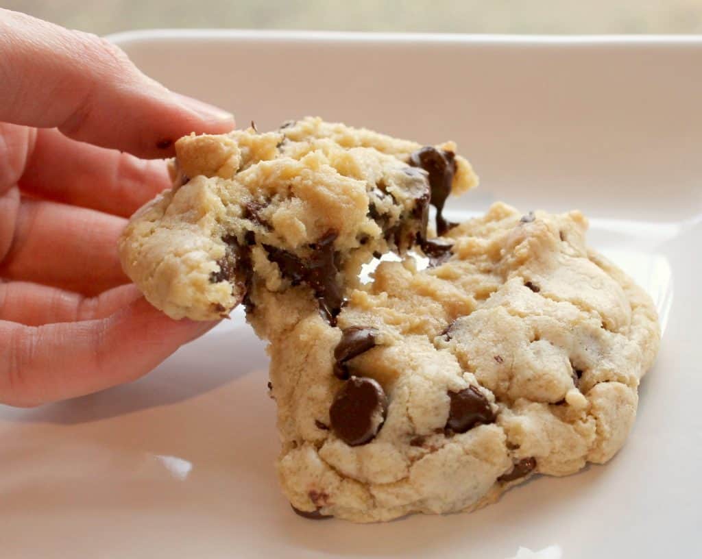 These perfectly chewy chocolate chip cookies will knock your socks off! They are delightfully soft, chock full of chips, and have a deep flavor from the brown sugar and melted butter. Click through to learn how to make them!