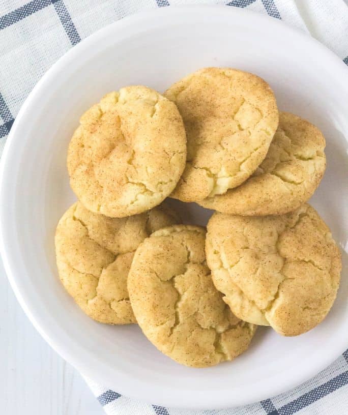 soft and chewy snickerdoodles on a white plate