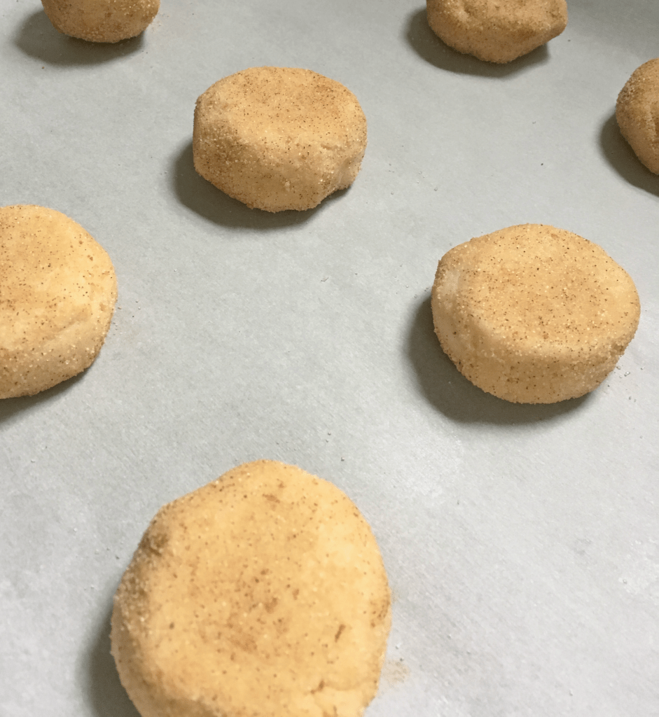 cookie dough for snickerdoodles on a baking sheet