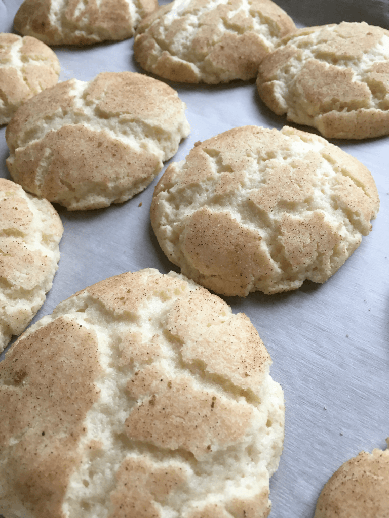 freshly baked snickerdoodles on a baking sheet