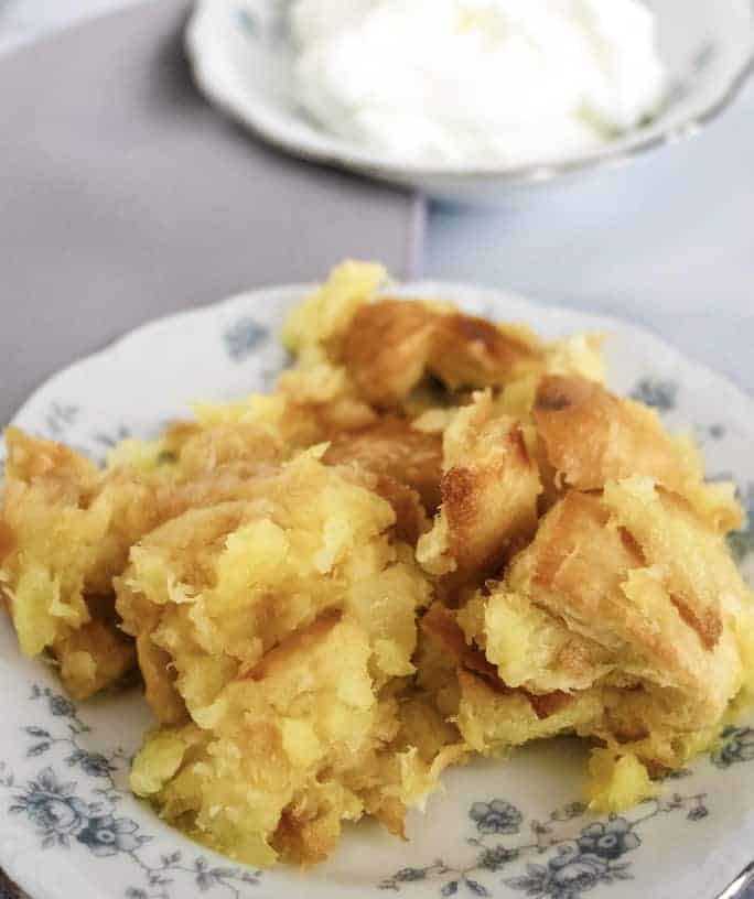 white and blue dish of scalloped pineapple stuffing