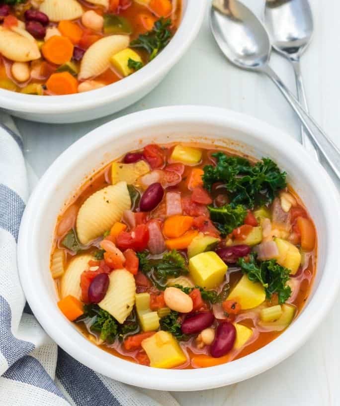 two white bowls filled with pressure cooker minestrone soup