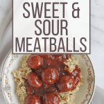 China bowl full of brown rice topped with Instant Pot sweet and sour meatballs and sauce