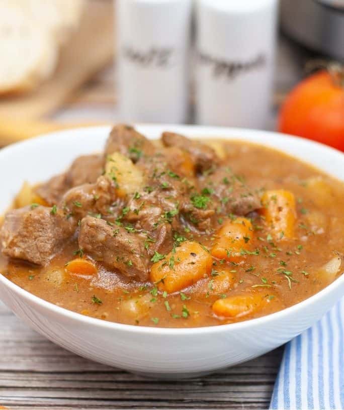 white bowl filled with pressure cooker beef stew prepared in the Instant Pot