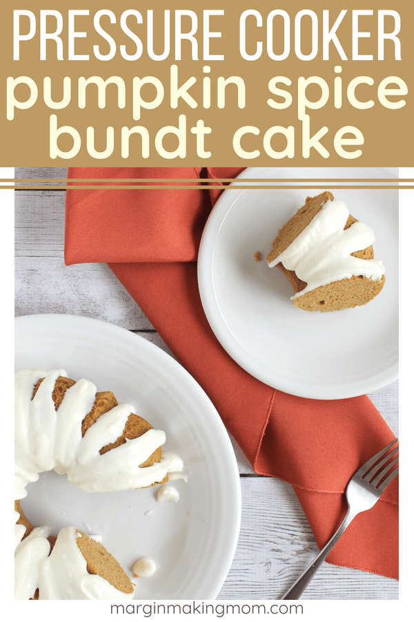 slice of pressure cooker pumpkin spice bundt cake ona white plate, accompanied by the whole cake on another serving plate. Orange cloth napkin under plates.