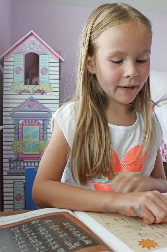 Girl with blond hair reading a book