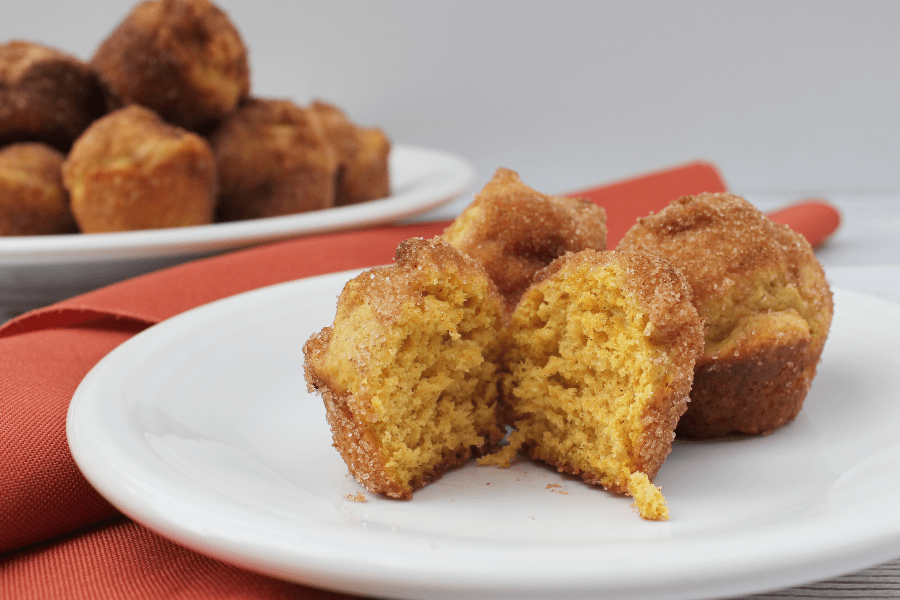 white plate with a pumpkin donut hole cut in half