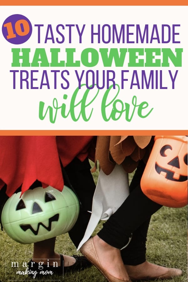 Green pumpkin bucket and orange pumpkin bucket in the hands of trick or treaters who are walking outside