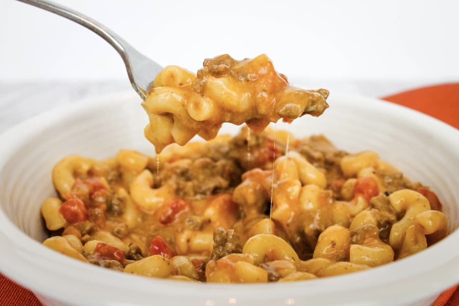 white bowl filled with cheeseburger macaroni being lifted out on a fork