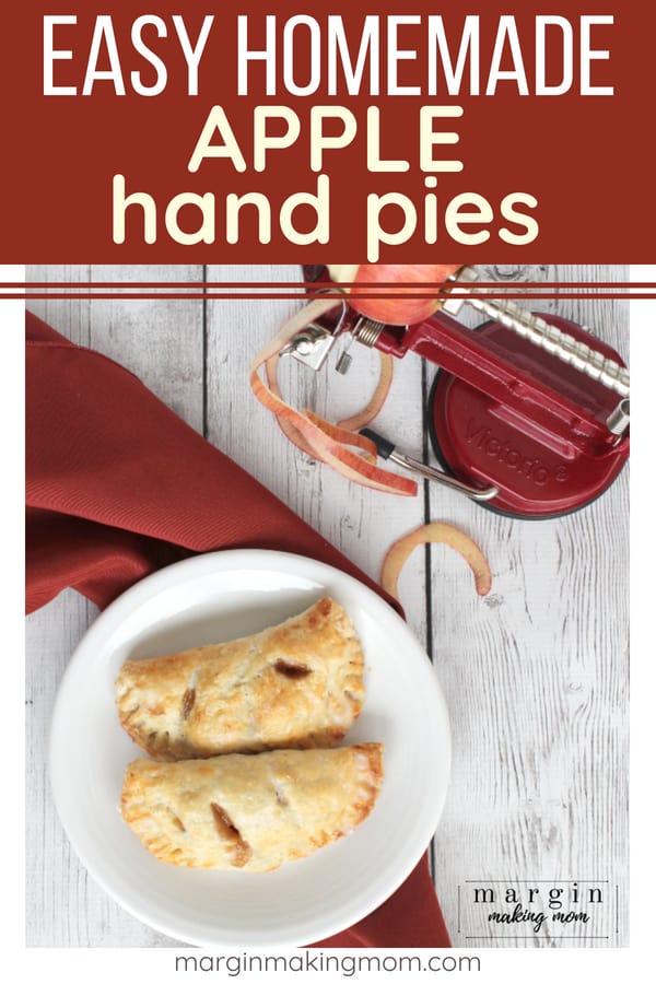 two easy apple hand pies resting on a white plate next to a apple peeler, corer, and slicer