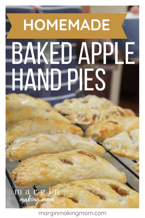 cooling rack topped with several baked apple hand pies