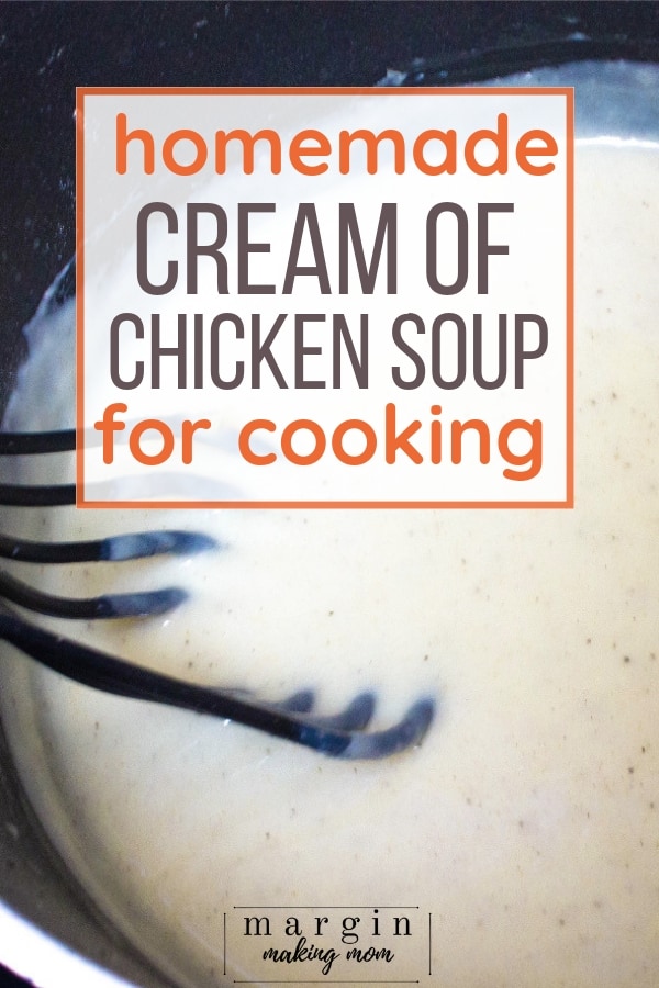 black whisk stirring homemade crema of chicken soup