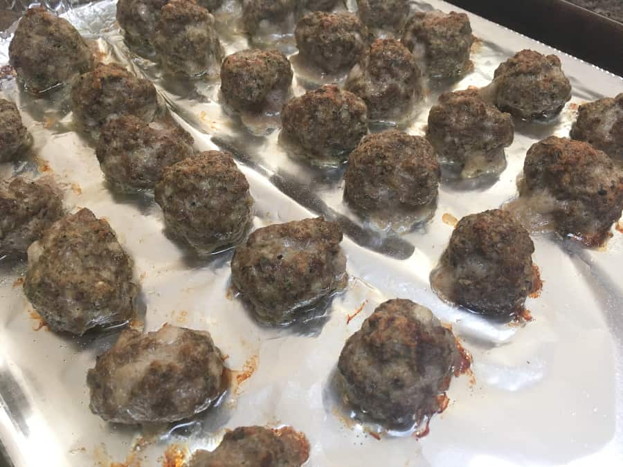 baked meatballs on a foil-lined baking sheet