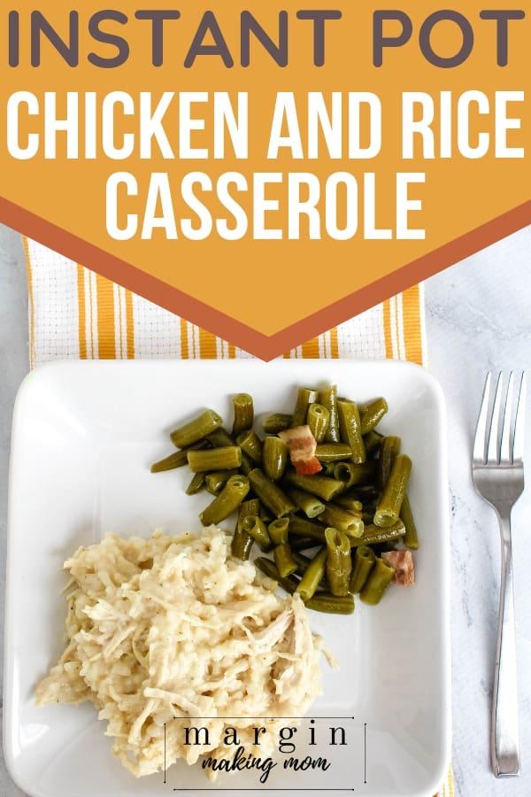 white plate topped with chicken and rice and green beans. The plate is resting on a yellow and white striped hand towel, with a fork next to it