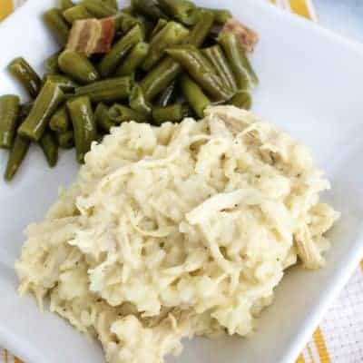 white plate with Instant Pot chicken and rice casserole on it, alongside green beans