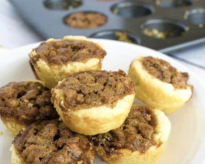 pecan pickups on a white plate with a muffin tin in the background