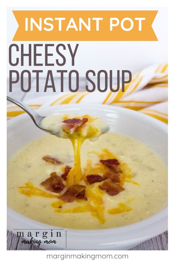 white bowl filled with instant pot potato soup, topped with bacon crumbles and melted cheese