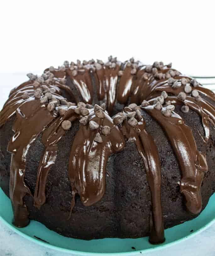 triple chocolate bundt cake on a teal plate