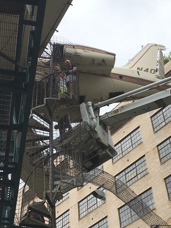 Dad and kids climbing outside of the City Museum in St. Louis