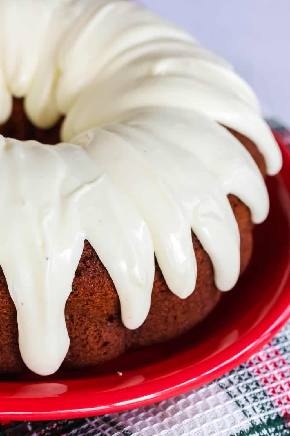 close-up view of eggnog icing drizzled over an eggnog bundt cake made from a cake mix.