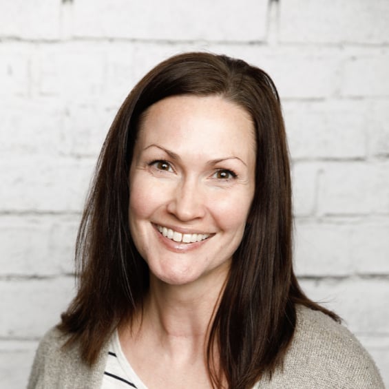 Chrysti Benner, author of Margin Making Mom, in front of a white brick wall.