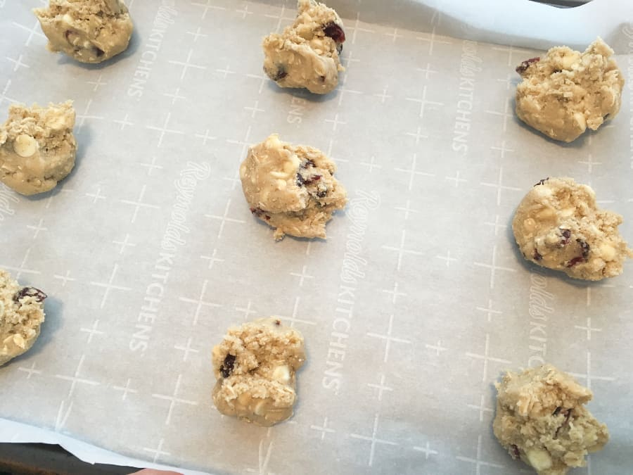 White Chocolate Oatmeal Cranberry Cookie Dough on a Parchment Lined Baking Sheet