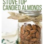 glass jar of candied almonds wrapped with a sparkly gold ribbon