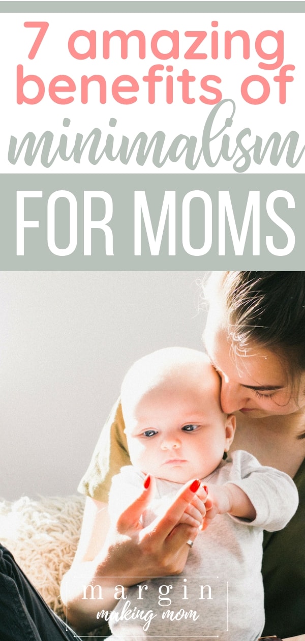 A woman is enjoying the benefits of minimalism for moms while holding her baby in a simple room