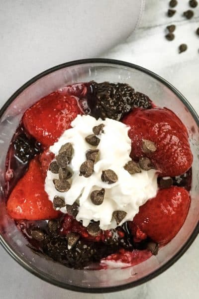 vegan overnight dark chocolate chia seed pudding with berries and cream