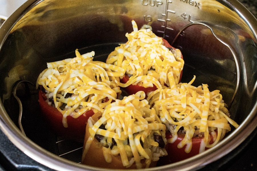 Mexican stuffed peppers in the Instant Pot with shredded cheese on top