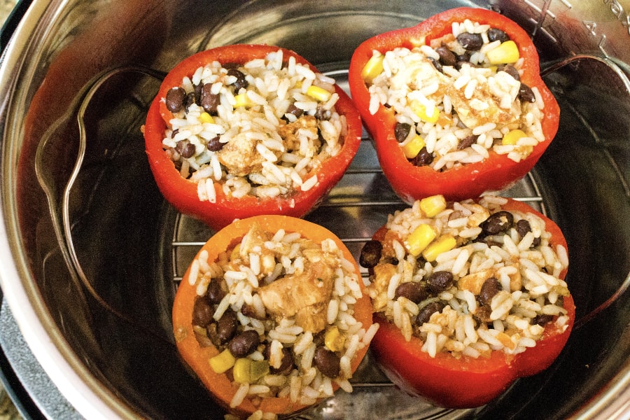 Uncooked stuffed bell peppers in the Instant Pot pressure cooker prior to cooking
