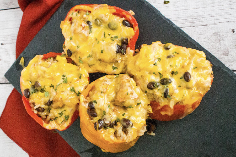 Instant Pot Mexican Chicken Stuffed Peppers resting on a black slate plate