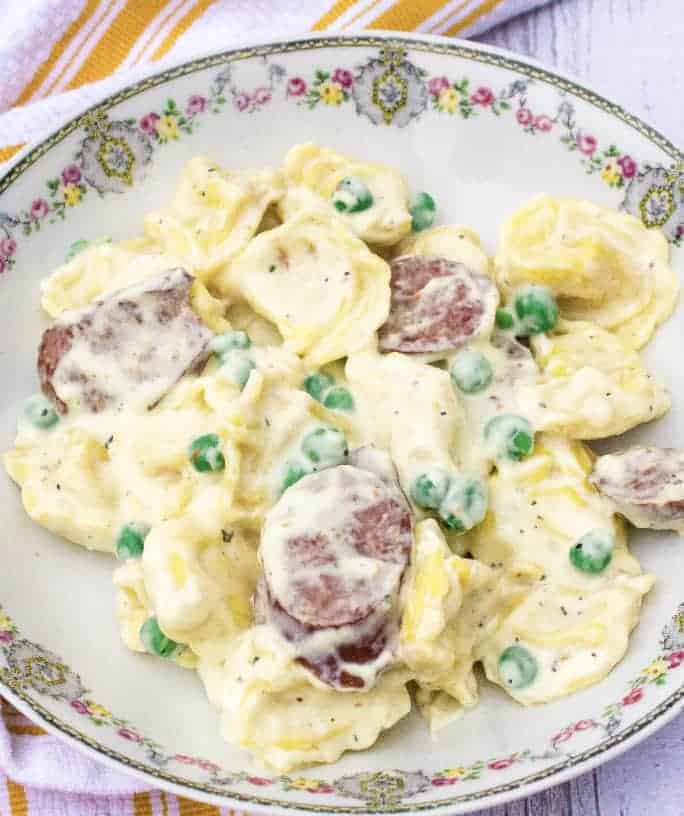 bowl filled with Instant Pot creamy tortellini and sausage