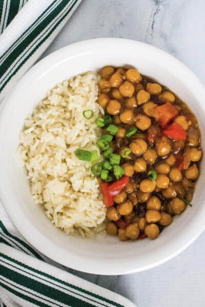 white bowl filled with white rice and kung pao chickpeas made in the Instant Pot